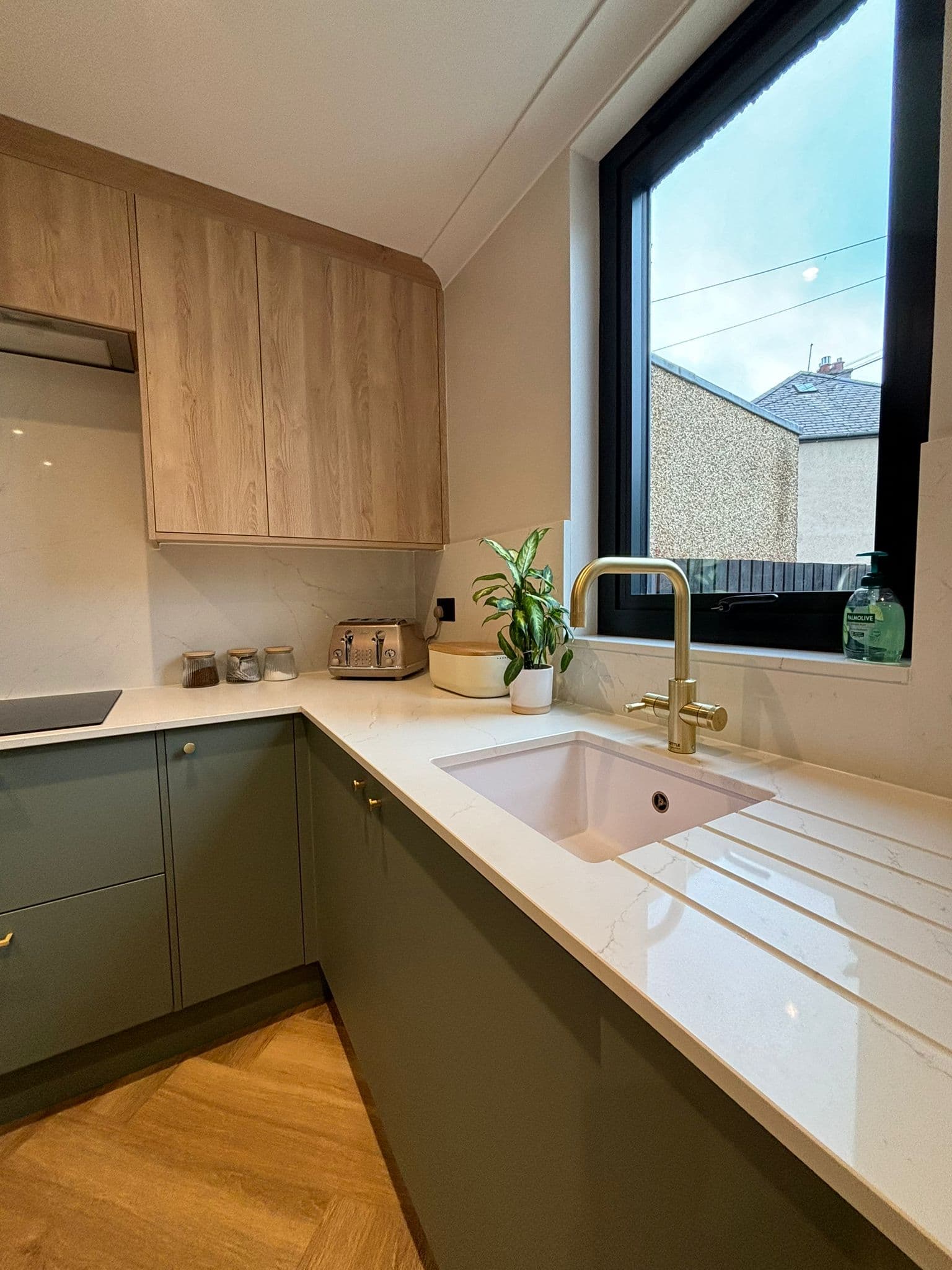 Bespoke sage green kitchen with copper handles and marble splashback